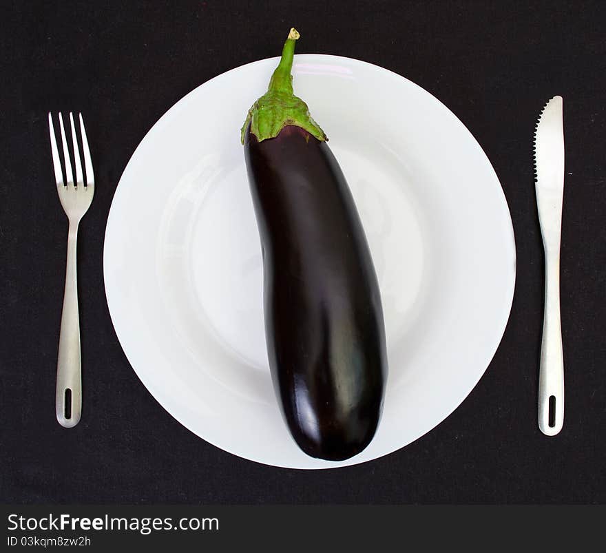 Eggplant on a white plate isolated