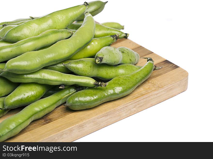 Close up view of some broad beans isolated on a white background.