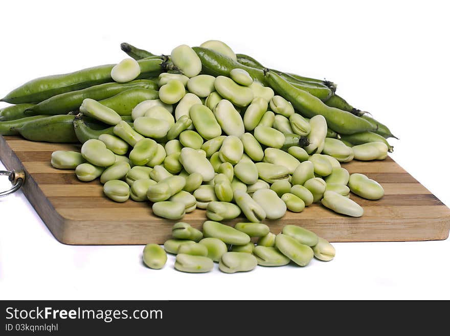 Close up view of some broad beans isolated on a white background.