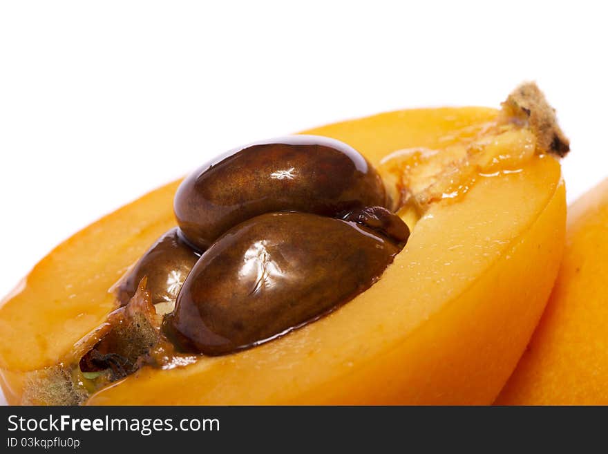 Close up view of some loquat fruit isolated on a white background.