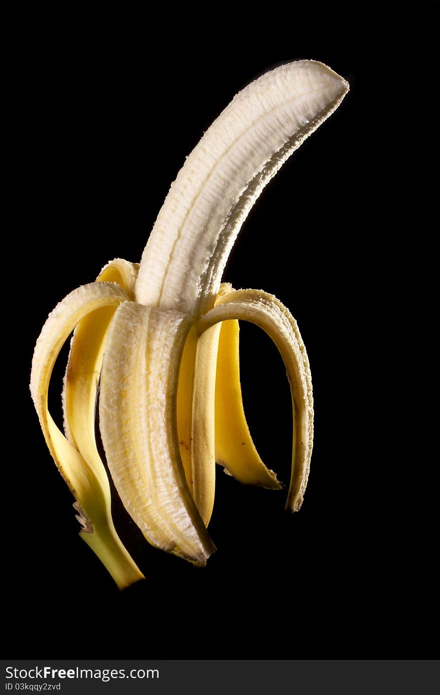 Close up view of peeled banana isolated on a black background. Close up view of peeled banana isolated on a black background.