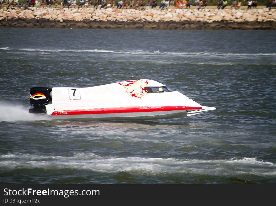 View of a powerboat race on a lake in Portugal. View of a powerboat race on a lake in Portugal.