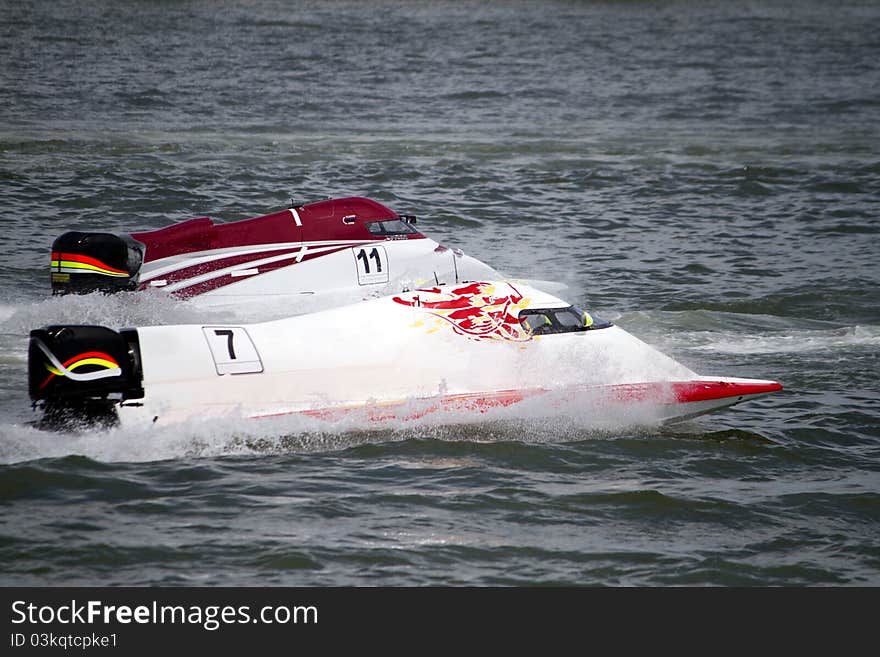 View of two powerboats racing on a lake in Portugal. View of two powerboats racing on a lake in Portugal.