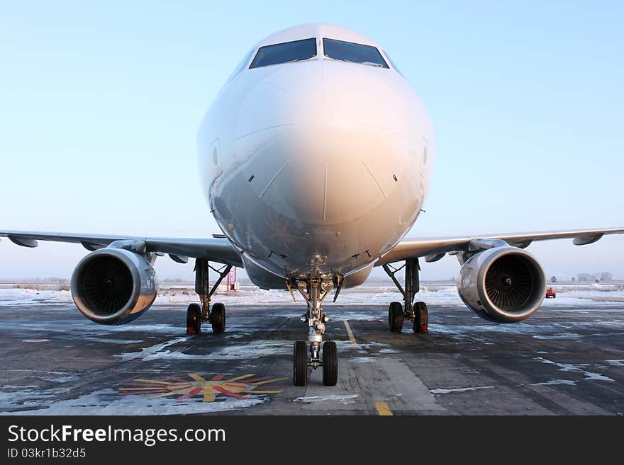 The plane on parking at the airport. The plane on parking at the airport.