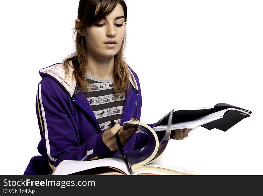 View of a teenager school girl studying on a white background. View of a teenager school girl studying on a white background.