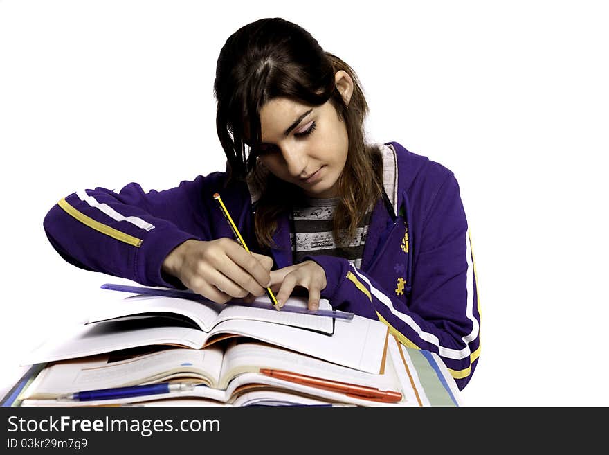 View of a teenager school girl studying on a white background. View of a teenager school girl studying on a white background.