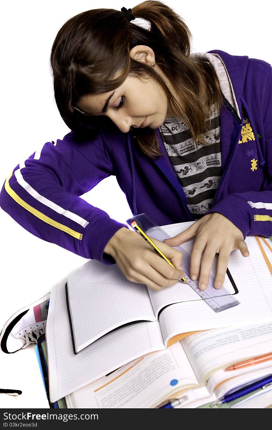 View of a teenager school girl studying on a white background. View of a teenager school girl studying on a white background.