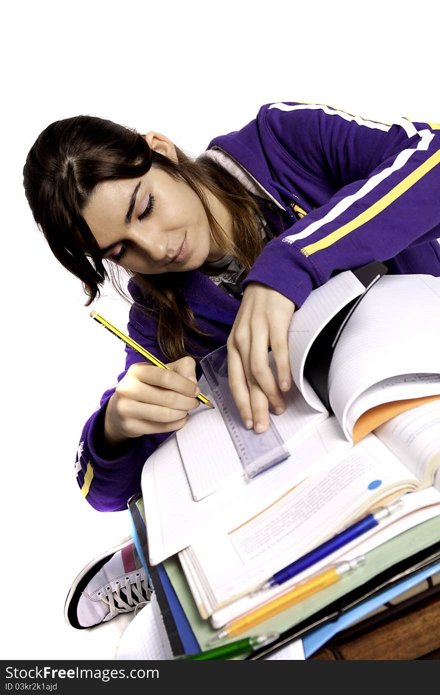 View of a teenager school girl studying on a white background. View of a teenager school girl studying on a white background.