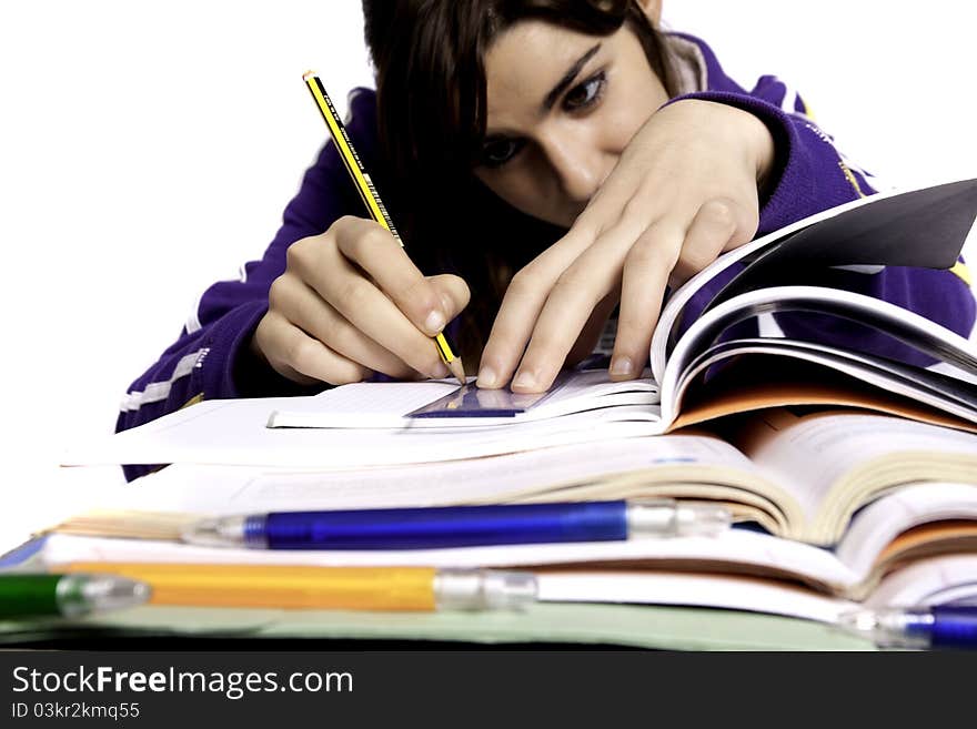 View of a teenager school girl studying on a white background. View of a teenager school girl studying on a white background.