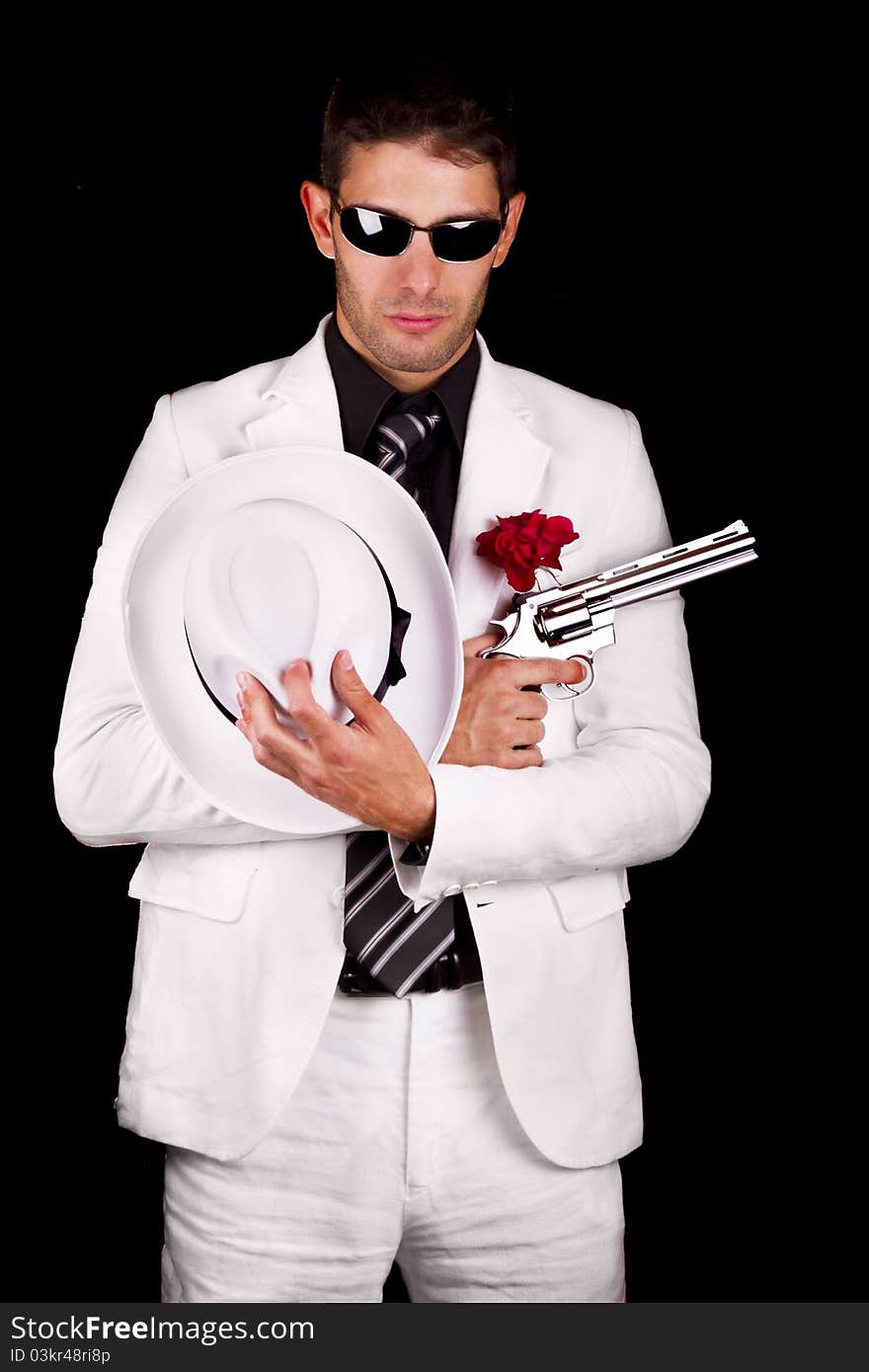 View of a white suit gangster man holding a gun.