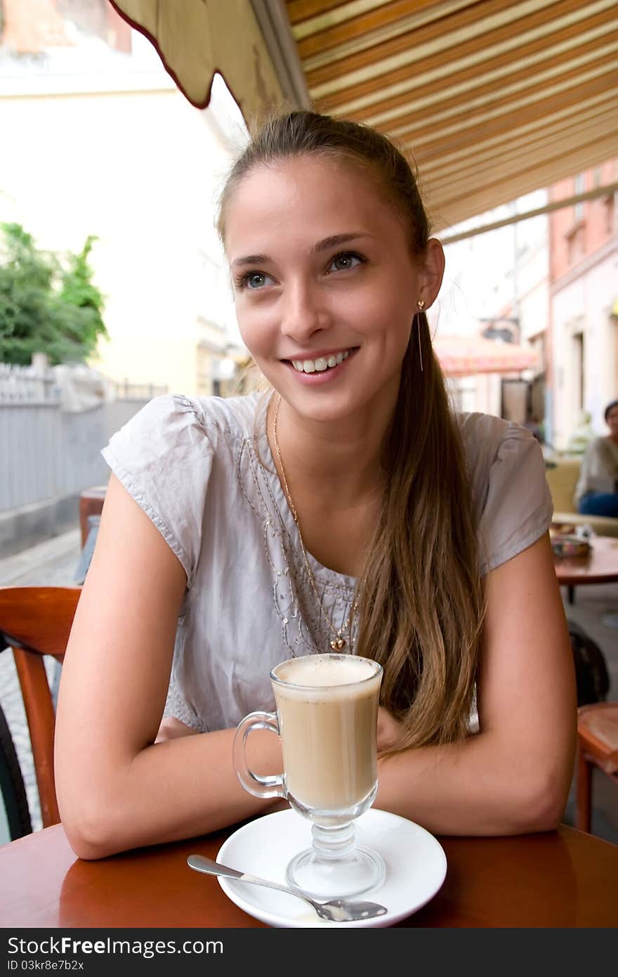 Woman with coffee in cafe