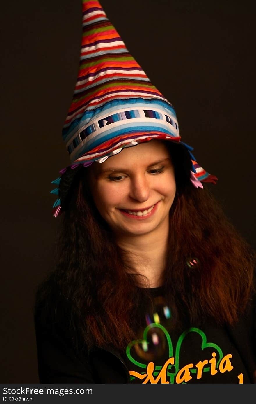 Young smiling girl in fool s cap.