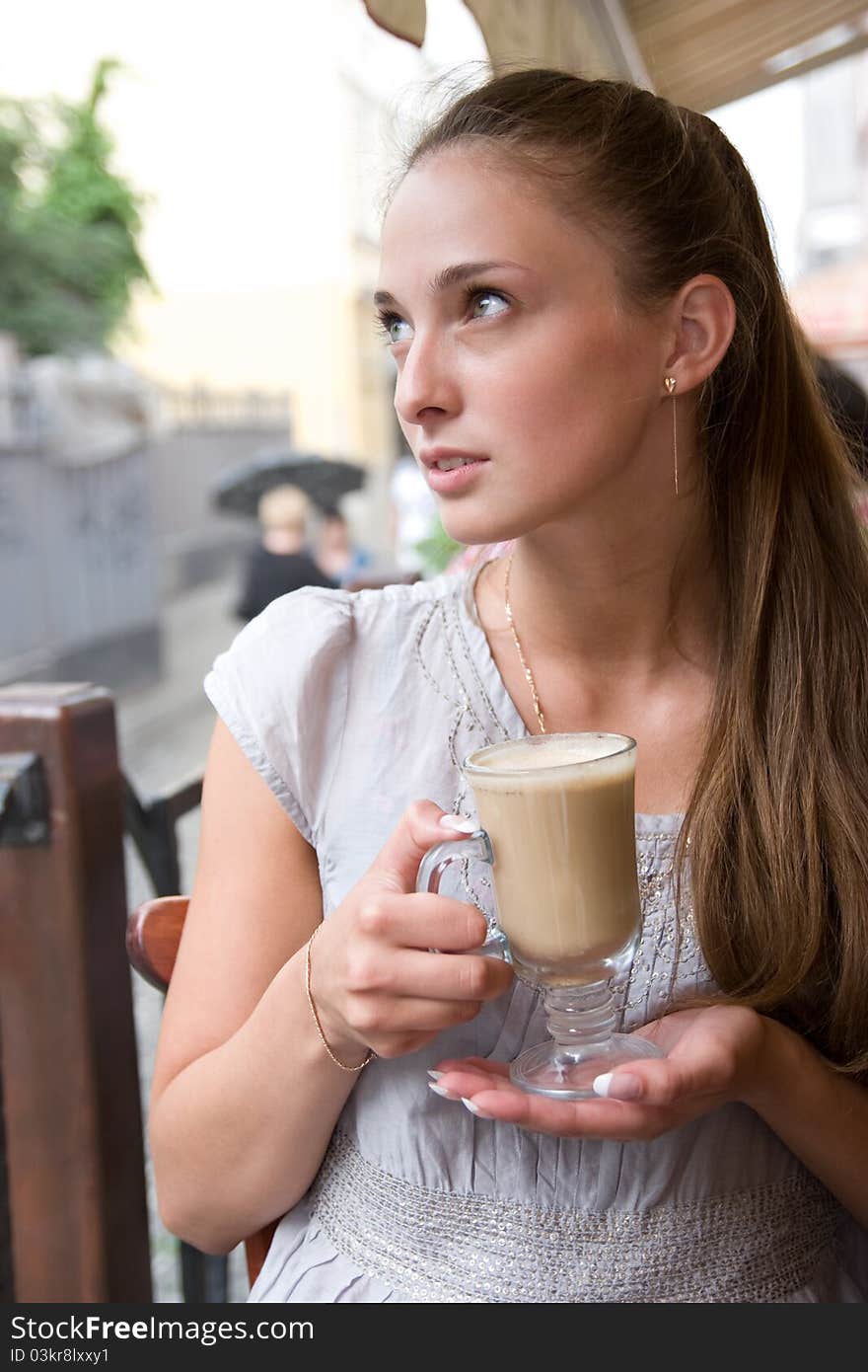 Woman is holding cappuccino