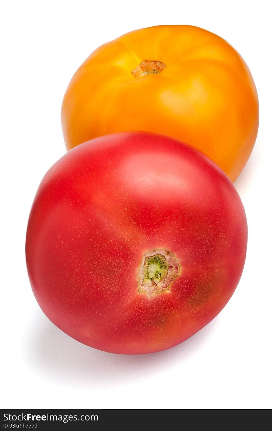 Two tomatoes isolated on white