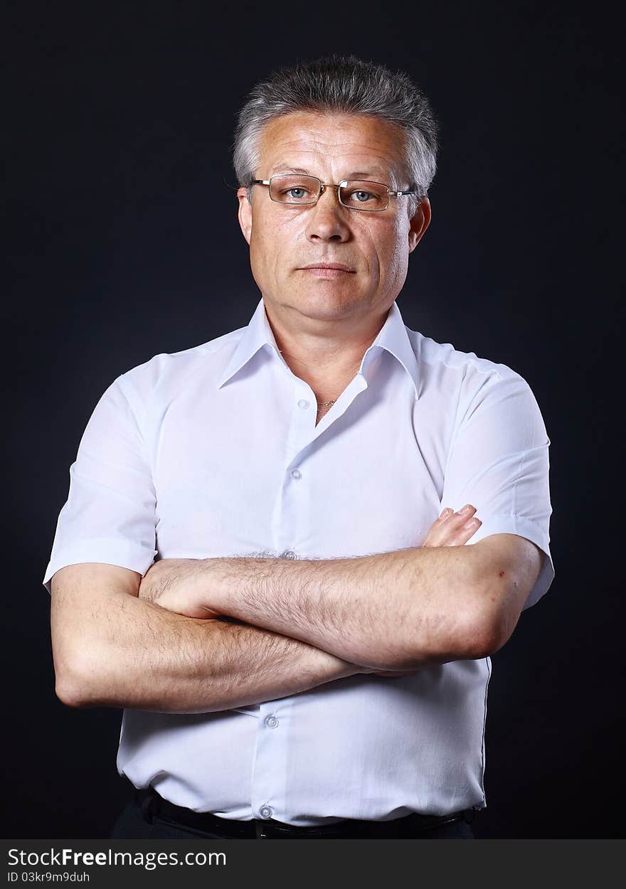 Portrait of successful business man standing on black background. Portrait of successful business man standing on black background