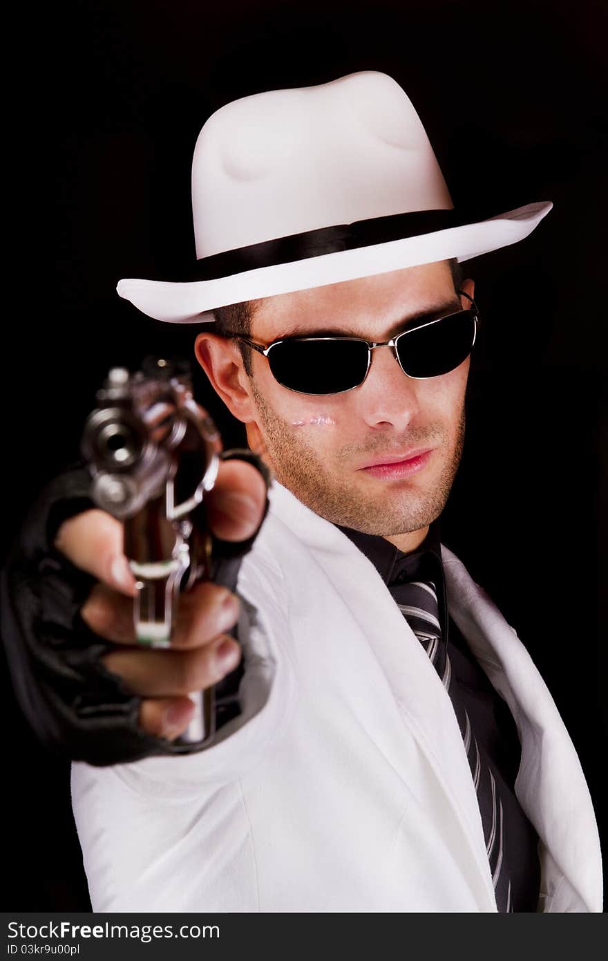 View of a white suit gangster man holding a gun. View of a white suit gangster man holding a gun.