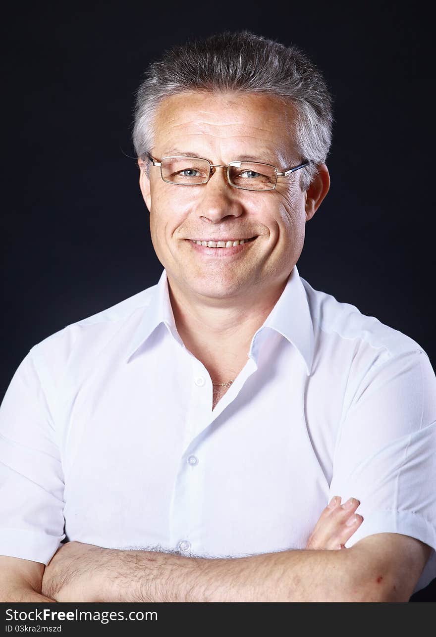 Portrait of successful business man standing on black background. Portrait of successful business man standing on black background