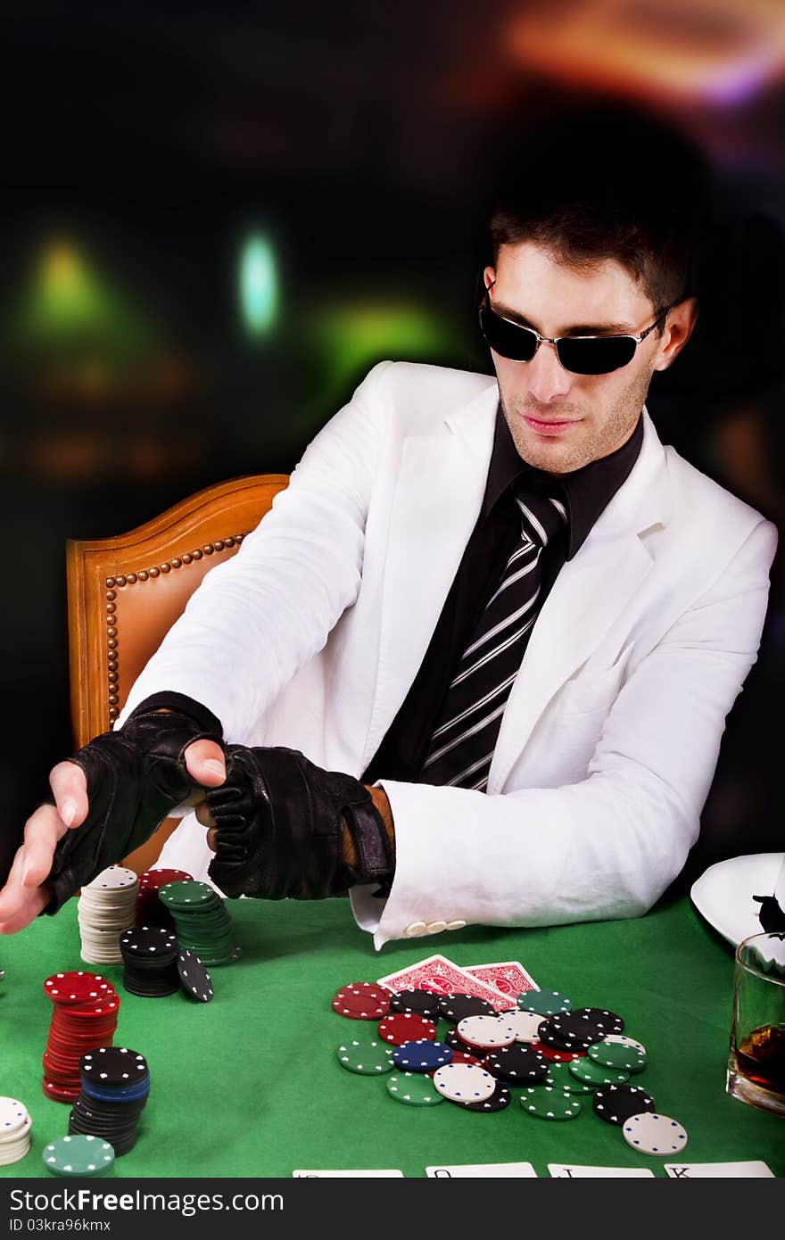 View of a gangster man playing some cards and poker. View of a gangster man playing some cards and poker.