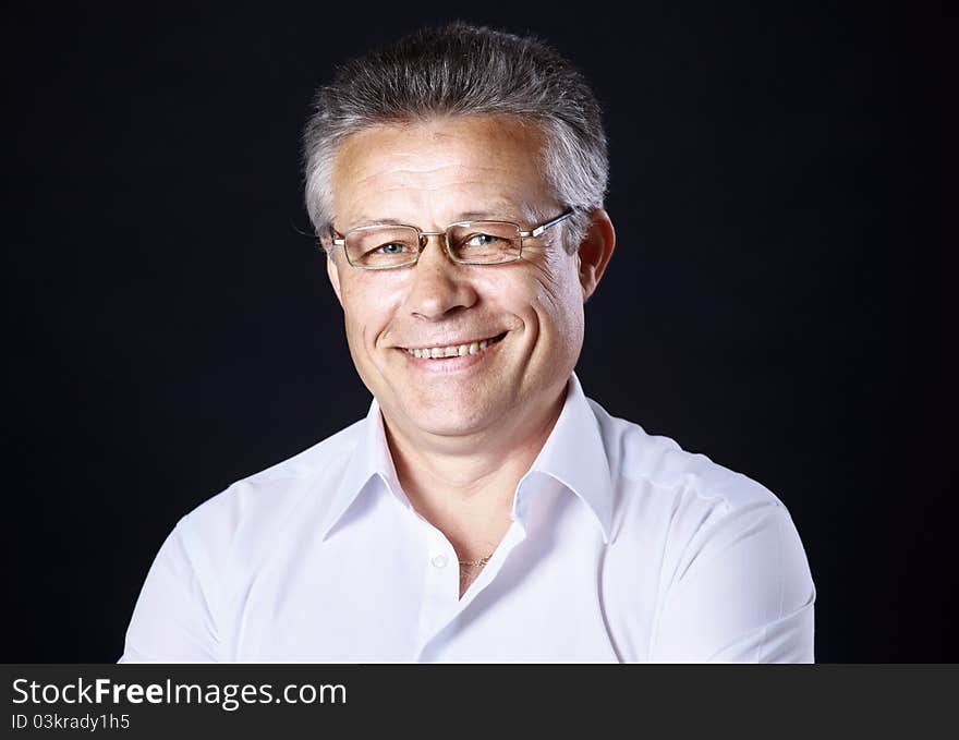 Portrait of successful business man standing on black background. Portrait of successful business man standing on black background