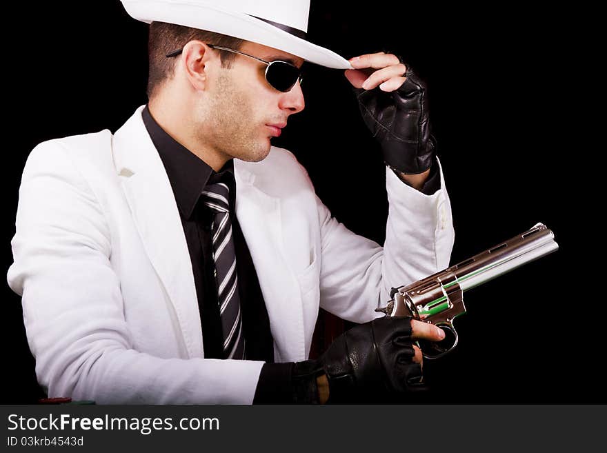 View of a white suit gangster man holding a gun.