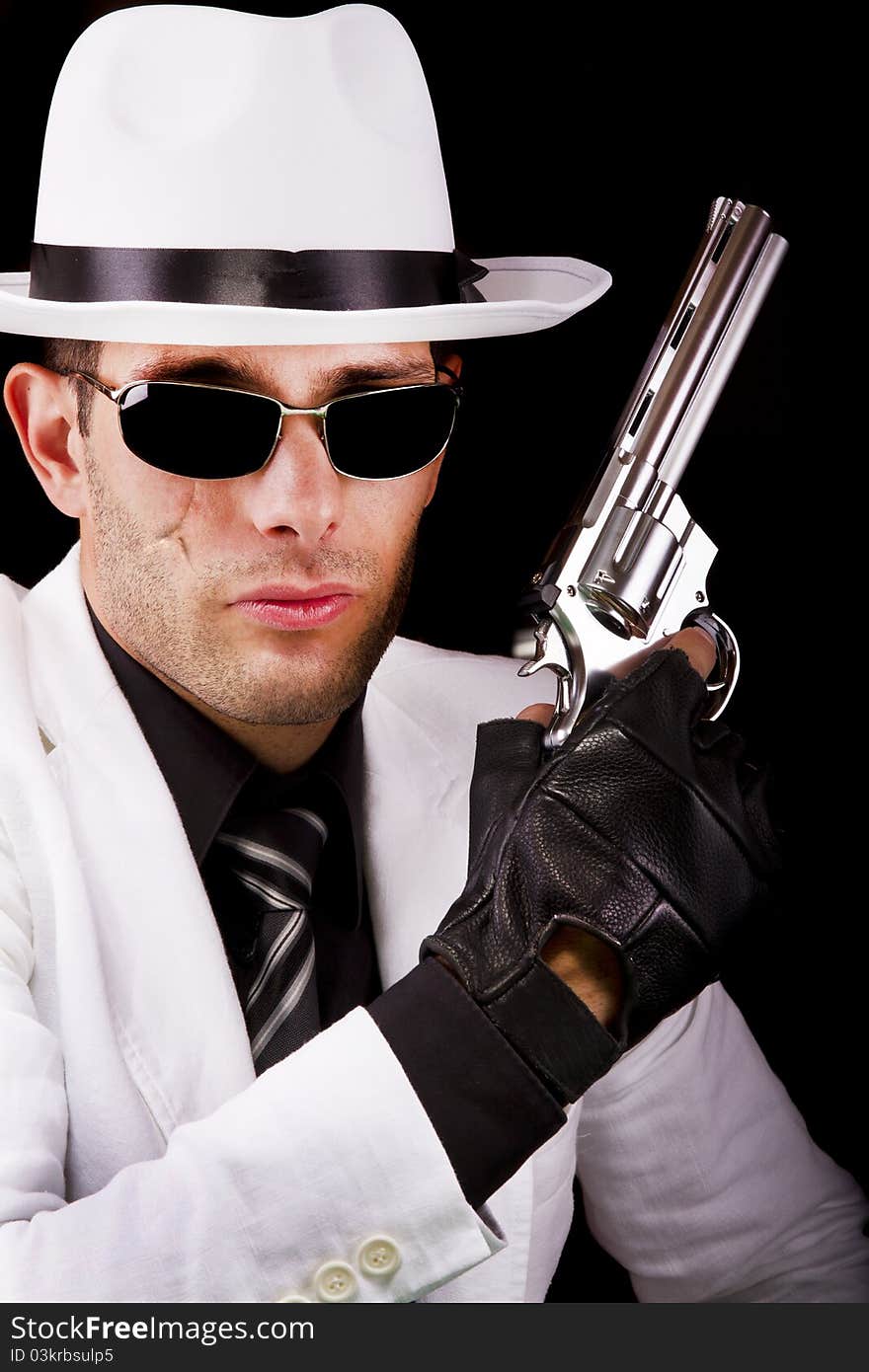 View of a white suit gangster man holding a gun.