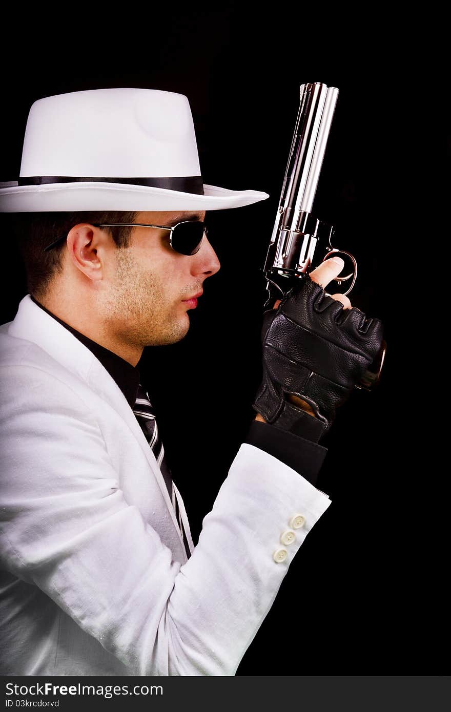 View of a white suit gangster man holding a gun.