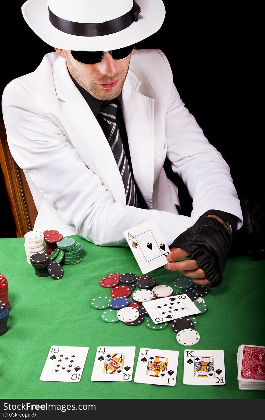 View of a gangster man playing some cards and poker. View of a gangster man playing some cards and poker.