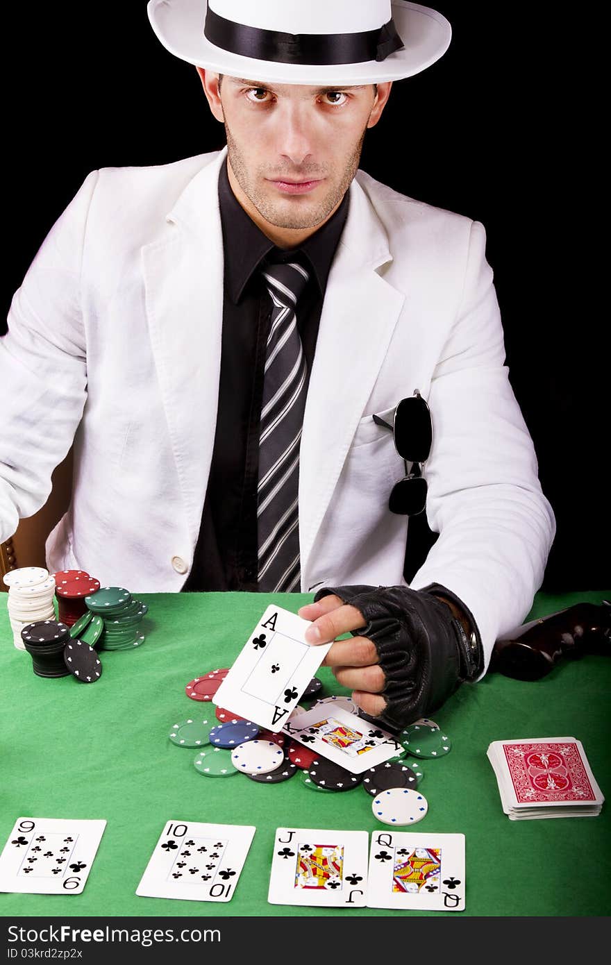 View of a gangster man playing some cards and poker. View of a gangster man playing some cards and poker.