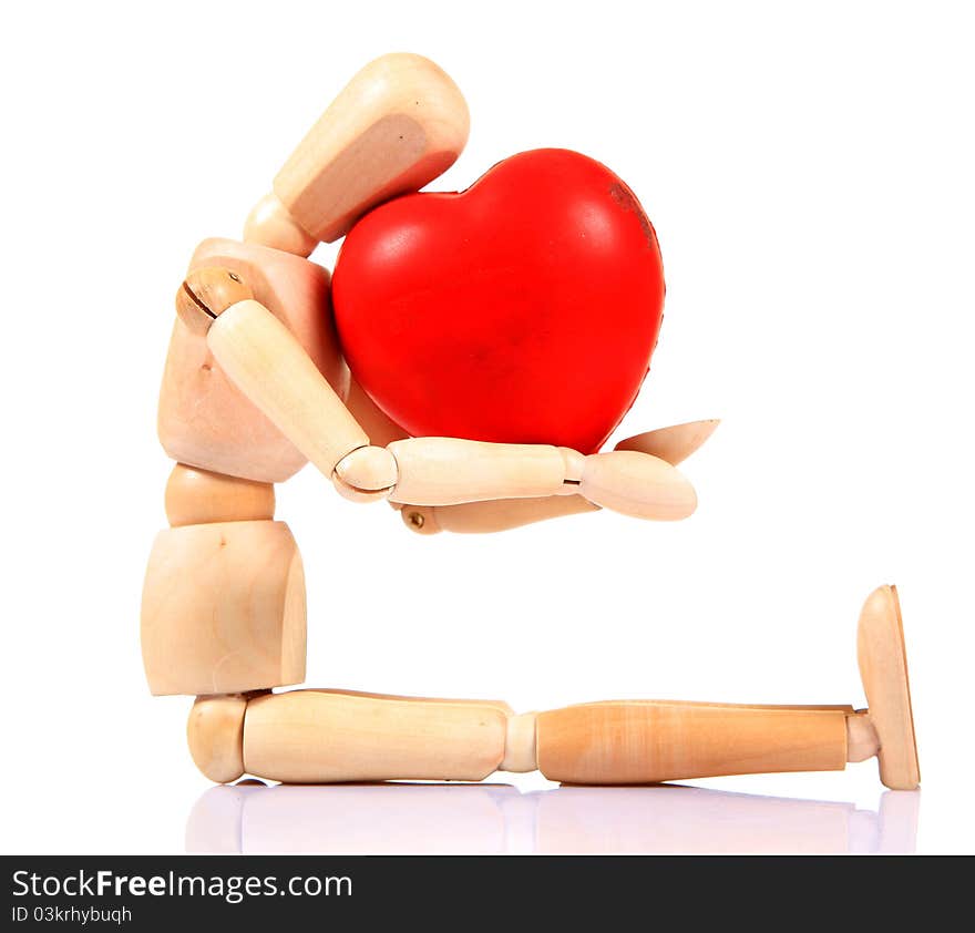 Wooden mannequin holding heart over white background. Wooden mannequin holding heart over white background.