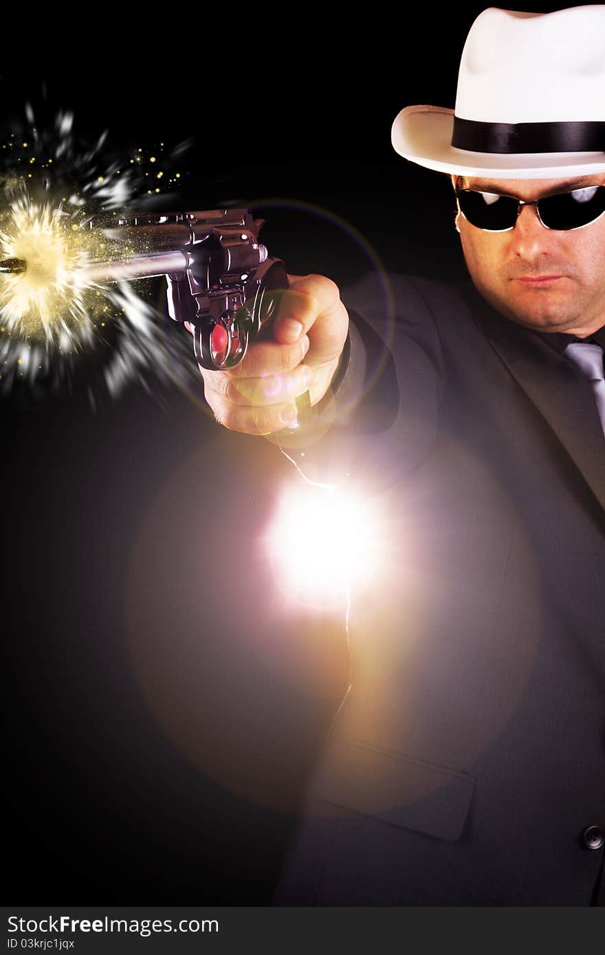 View of a dark suit gangster man firing a gun. View of a dark suit gangster man firing a gun.