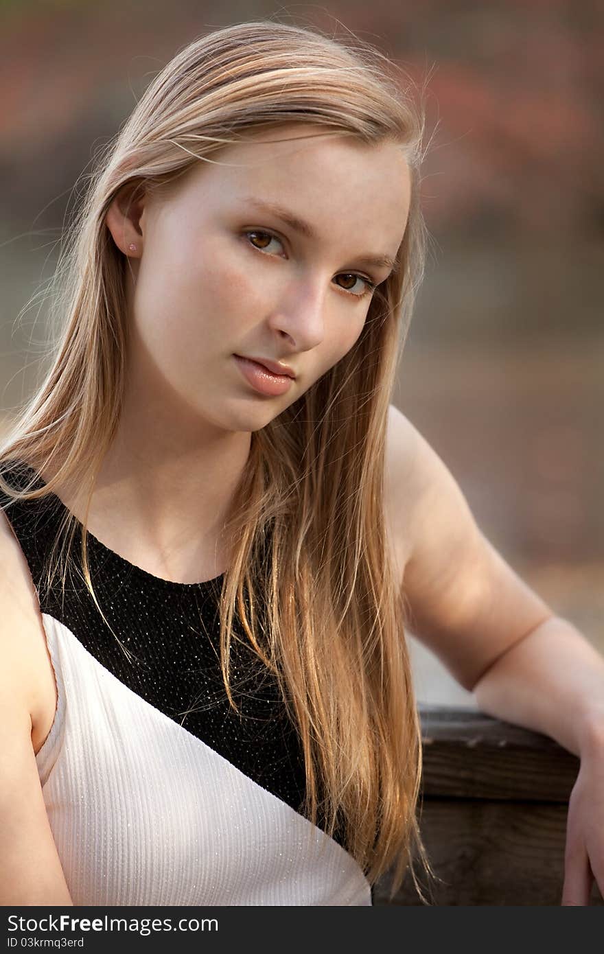 A portrait of a pretty teenager, outside and lit by sunlight. A portrait of a pretty teenager, outside and lit by sunlight