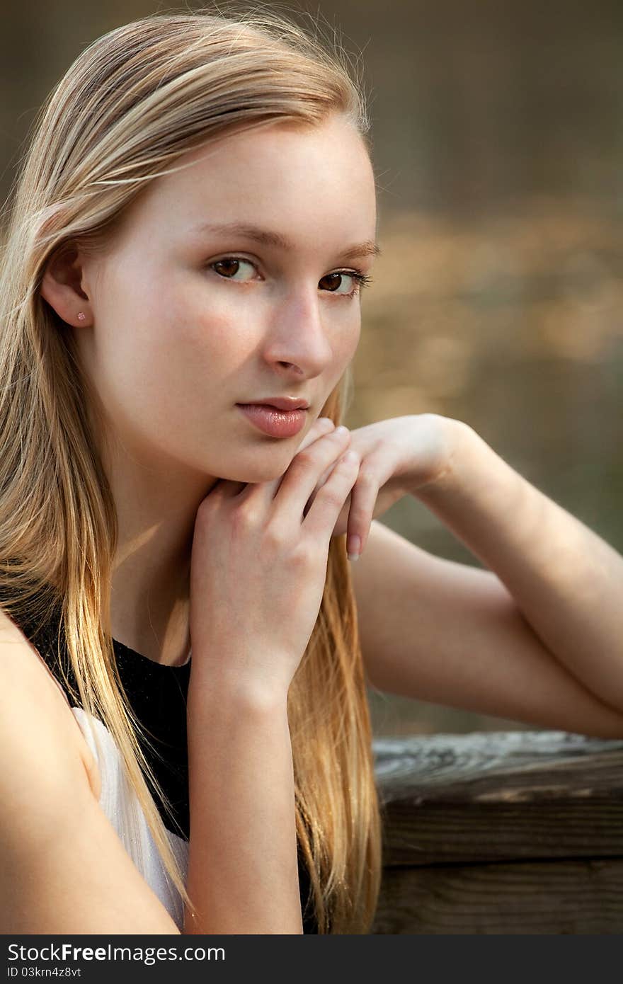 A portrait of a pretty teenager, outside and lit by sunlight. A portrait of a pretty teenager, outside and lit by sunlight