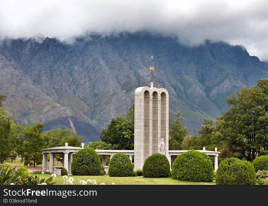 The Huguenot Monument in summer with green grass and blooming gardens in Franschhoek, Western Cape, South Africa. The Huguenot Monument in summer with green grass and blooming gardens in Franschhoek, Western Cape, South Africa