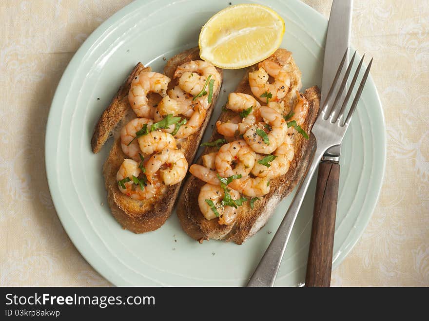 Toasted sourdough topped with king prawns and herbs. Toasted sourdough topped with king prawns and herbs