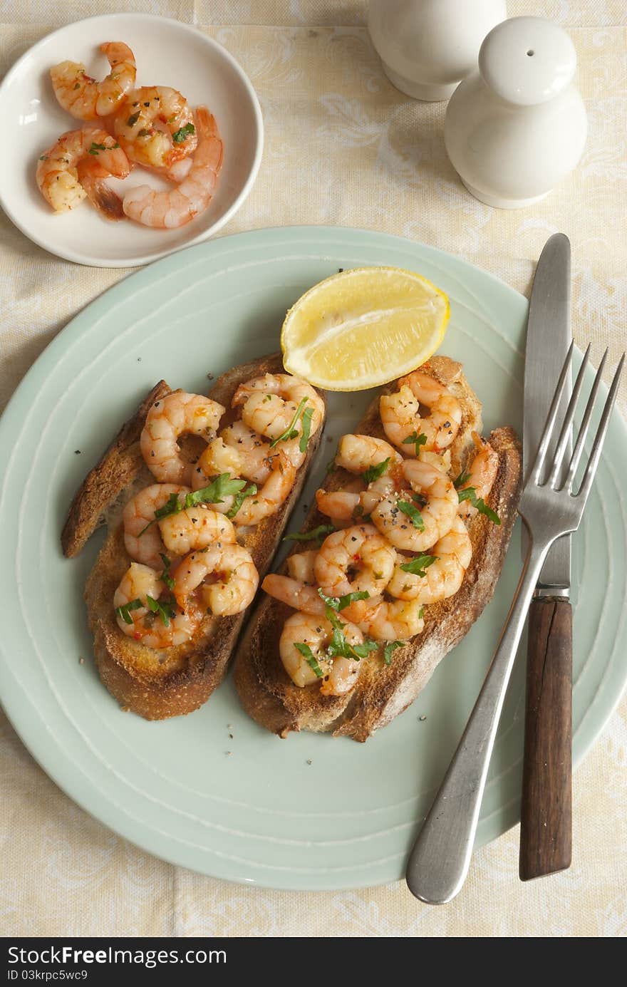 Toasted sourdough topped with king prawns and herbs. Toasted sourdough topped with king prawns and herbs