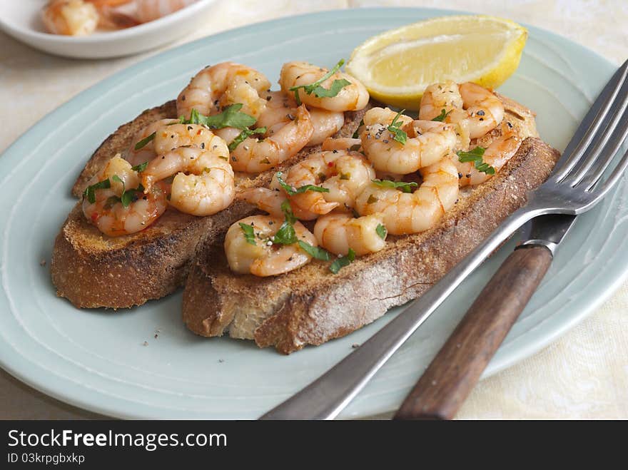 Toasted sourdough topped with king prawns and herbs. Toasted sourdough topped with king prawns and herbs