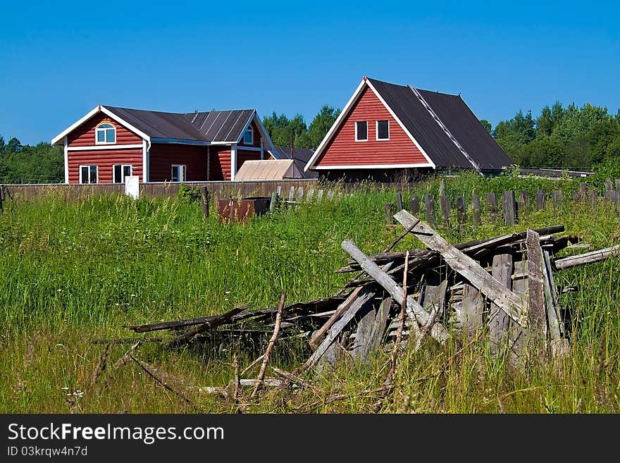 New houses and ruins at the background of grass and sky