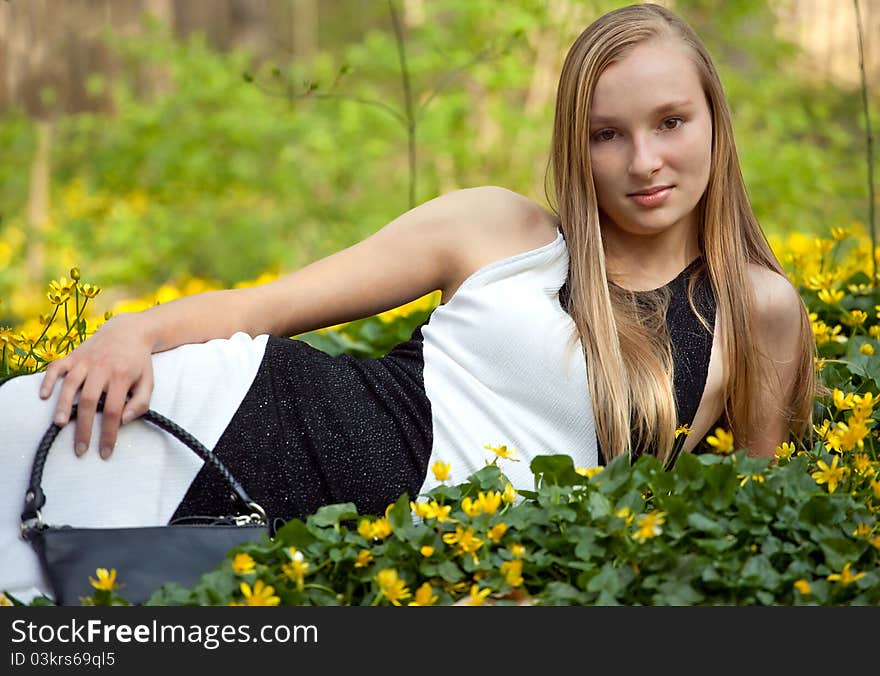 Pretty Teen in Gown Lying in Flowers