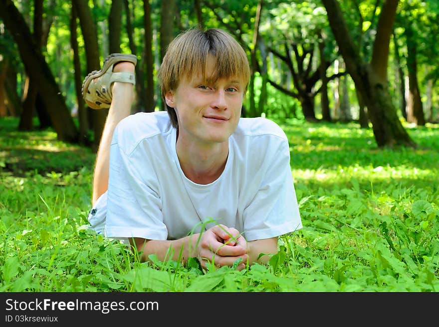 The man in the woods on the green grass