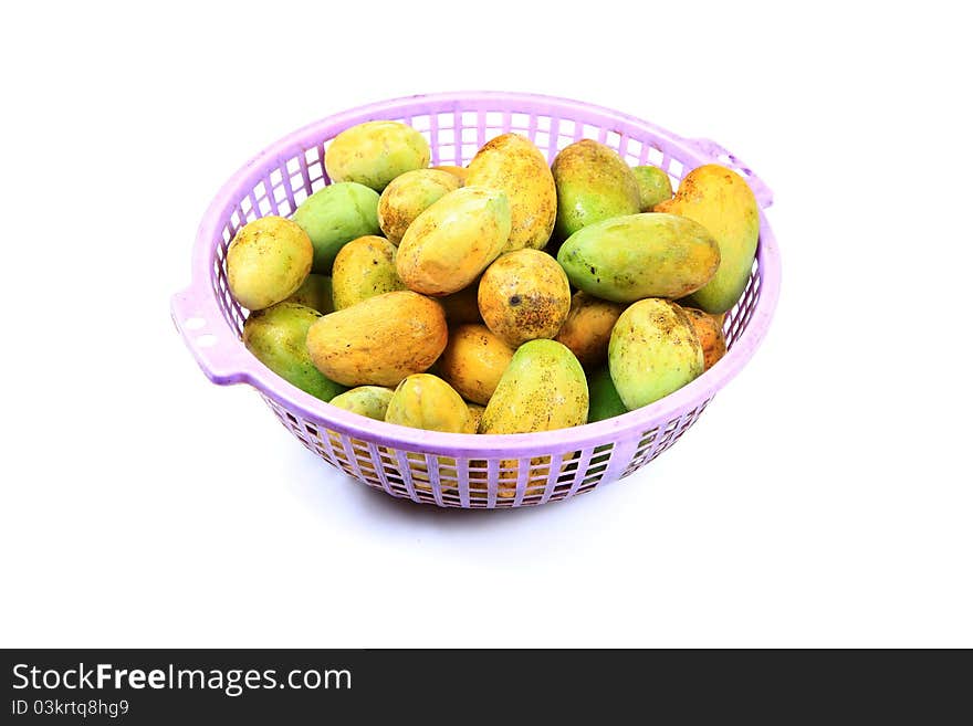 Ripe mangoes in basket over white background.