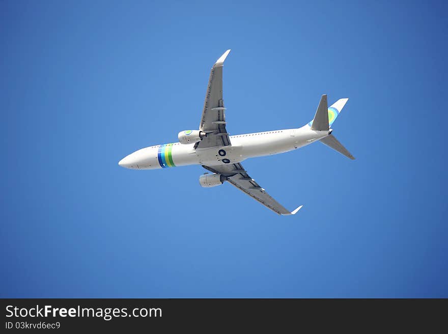 Airplane flying against a blue sky