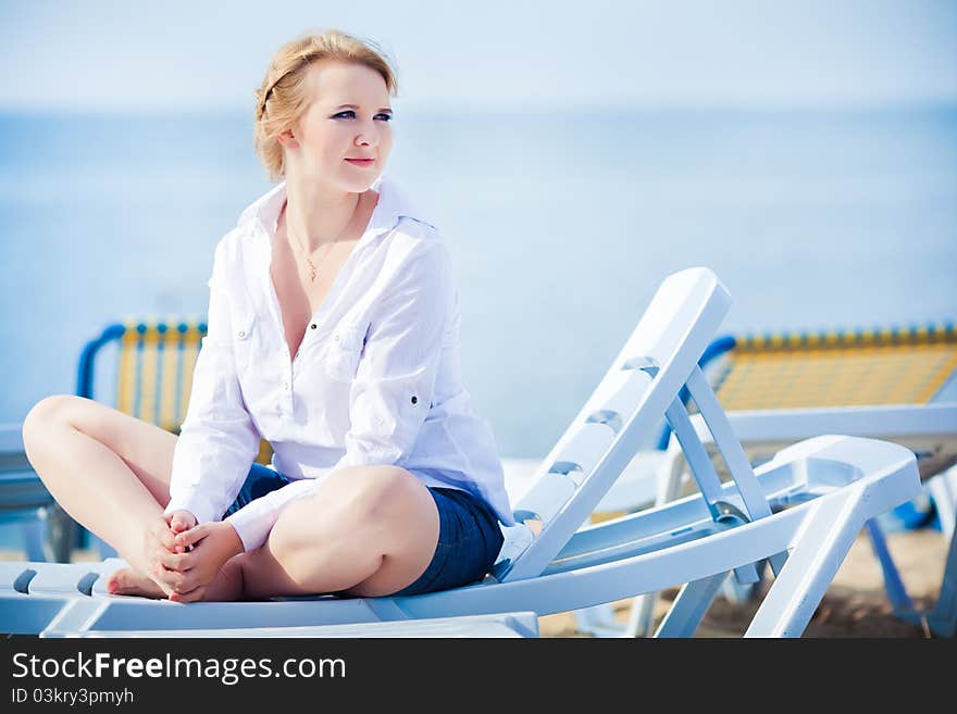 Beautiful woman sitting in chaise