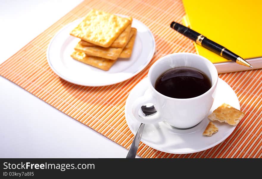 Hot coffee cup with bread on the work space