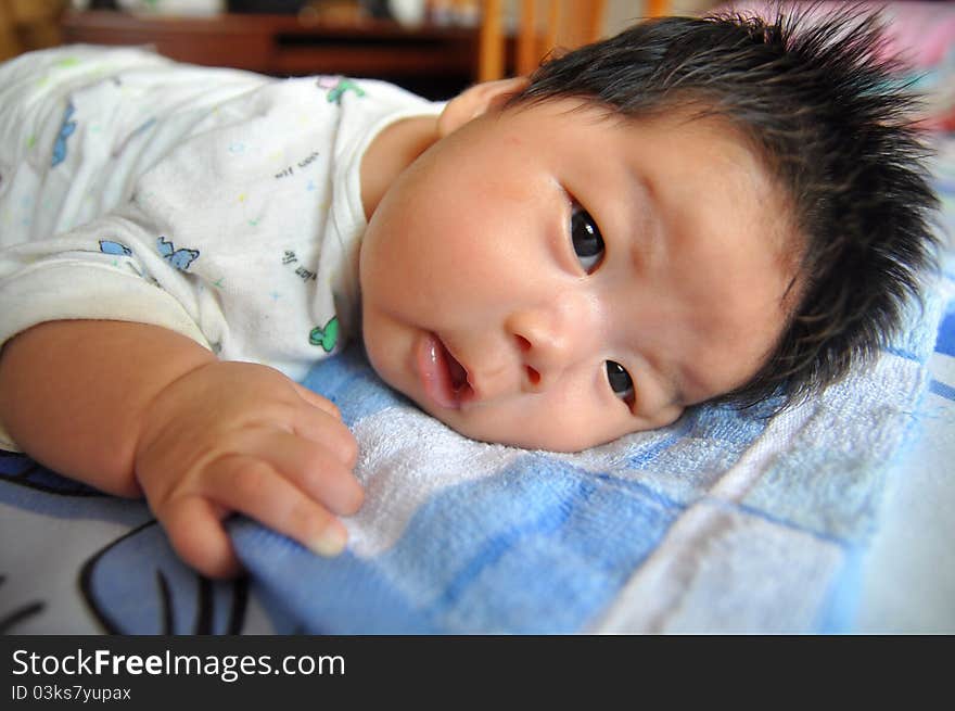 A 2 months chinese Baby girl lying on the bed. A 2 months chinese Baby girl lying on the bed