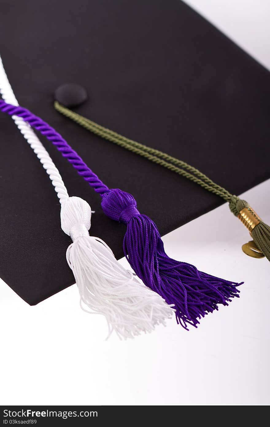 Graduation cap and tassles isolated on a white background