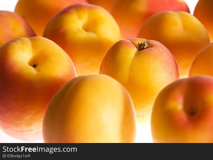 Background with ripe apricots on white