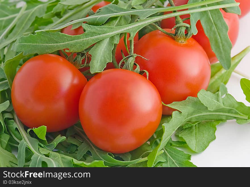 Tomatoes cherry with arugula leaves