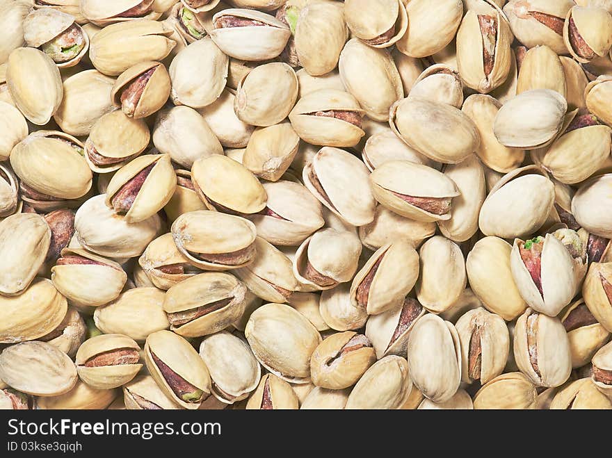 Background with many open salted pistachios. Background with many open salted pistachios