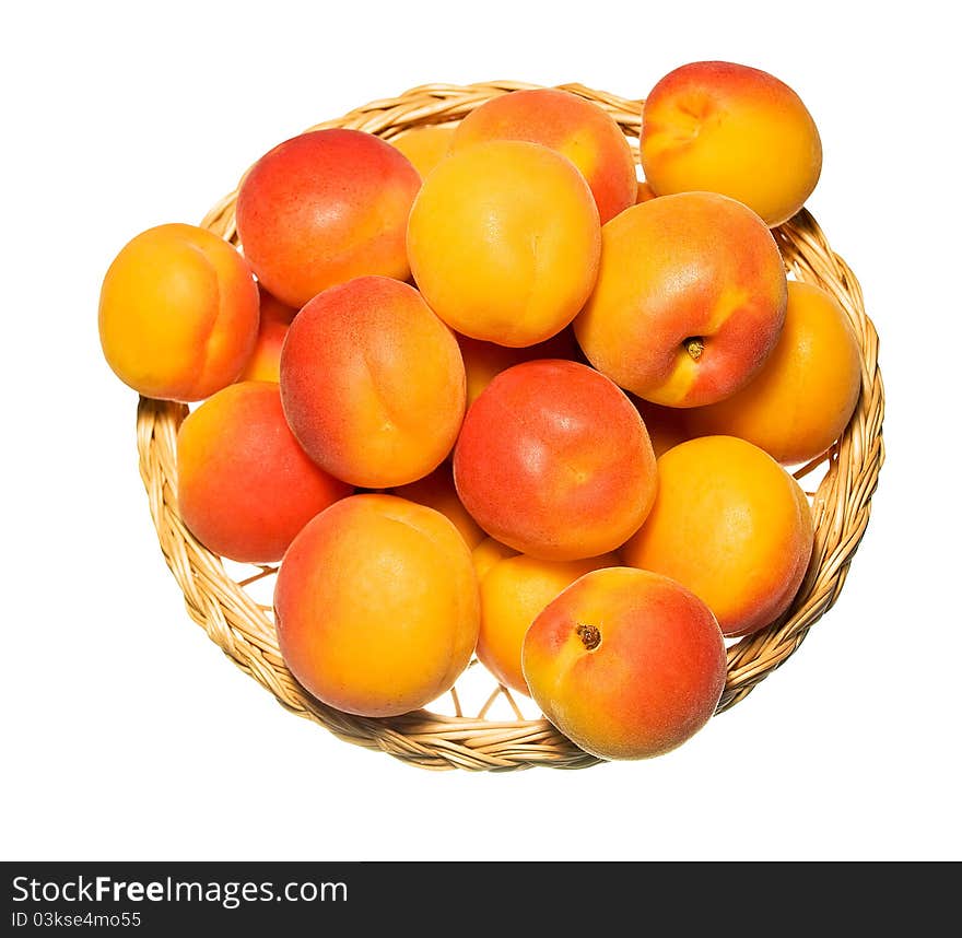 Basket full of apricots isolated on white