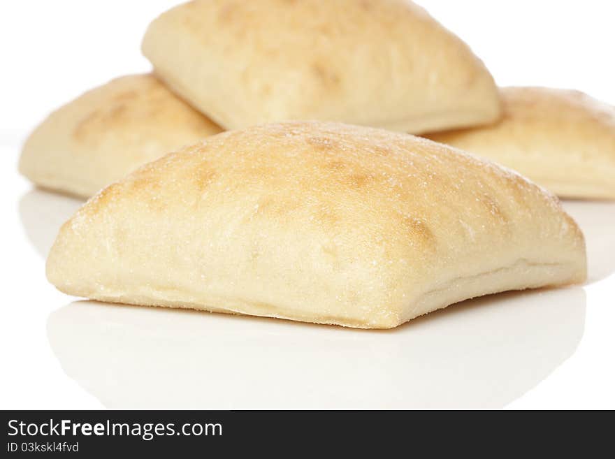 Fresh ciabatta bread against a white background